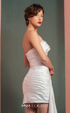 MNM Couture GOF2515 two-piece ensemble in white mikado piqué, featuring a strapless top with draped detailing and a matching high-waisted asymmetrical skirt with a cascading drape. | Couture Shop LA