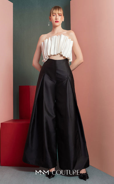 MNM Couture GOF2516 two-piece black-and-white ensemble, featuring a white pleated taffeta crop top and black high-waisted, wide-leg taffeta pants. | Couture Shop LA