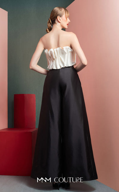 MNM Couture GOF2516 two-piece black-and-white ensemble, featuring a white pleated taffeta crop top and black high-waisted, wide-leg taffeta pants. | Couture Shop LA