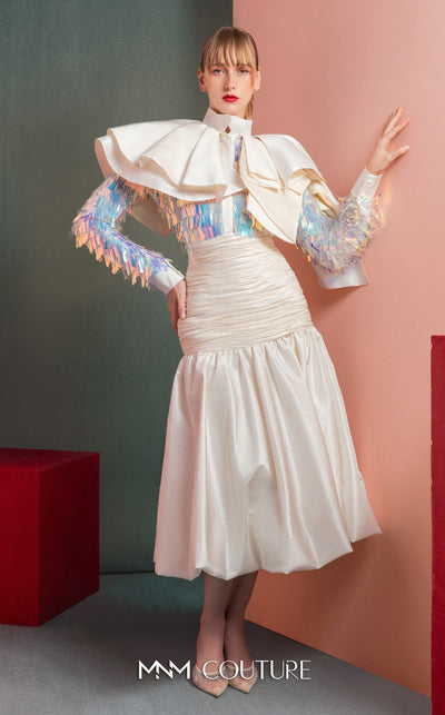 MNM Couture GOF2521 two-piece ensemble in white taffeta, featuring a top with dramatic shoulders and iridescent sequin embellishments, and a matching draped taffeta midi skirt. | Couture Shop LA