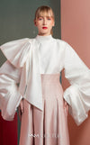 MNM Couture GOF2523 two-piece ensemble, featuring a white taffeta blouse with dramatically oversized sleeves and a front knot, paired with pink taffeta high-waisted, wide-leg pants. | Couture Shop LA