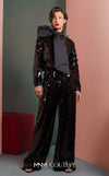 MNM Couture GOF2526 two-piece black sequin ensemble, featuring a long-sleeve blouse with a large taffeta bow at the neck and matching flared sequin pants. | Couture Shop LA