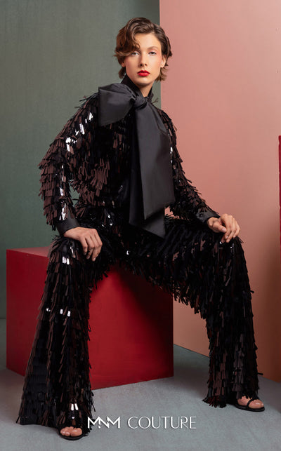 MNM Couture GOF2526 two-piece black sequin ensemble, featuring a long-sleeve blouse with a large taffeta bow at the neck and matching flared sequin pants. | Couture Shop LA