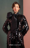 MNM Couture GOF2526 two-piece black sequin ensemble, featuring a long-sleeve blouse with a large taffeta bow at the neck and matching flared sequin pants. | Couture Shop LA