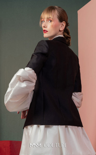 MNM Couture GOF2532 ensemble, featuring a high-low voluminous white taffeta skirt paired with a sharply tailored minimalist black blazer. | Couture Shop LA