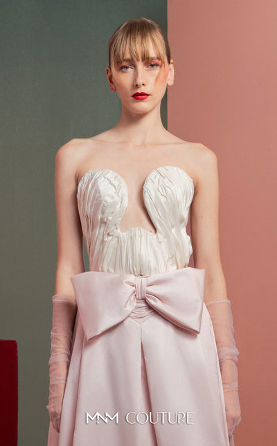 MNM Couture GOF2540 two-piece ensemble, featuring a structured white taffeta corset with draped detailing and a matching full-length taffeta skirt with a large bow accent at the waist. | Couture Shop LA