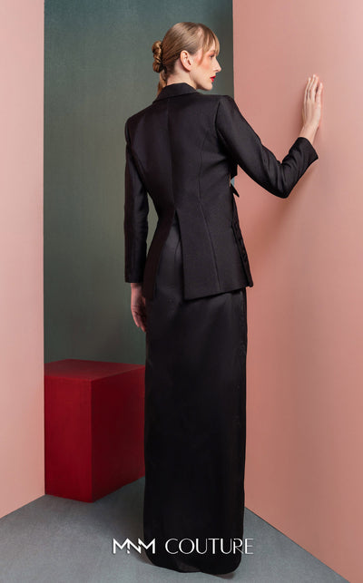 MNM Couture GOF2542 ensemble, with an asymmetrical black mikado piqu� blazer featuring side cut-outs and button details, paired with a dramatic high-slit black taffeta skirt. | Couture Shop LA