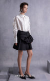 MNM Couture GOS2519 Black piqué skirt with bow design and off-white taffeta blouse with embroidered sleeves and cut-out shoulders. | Couture Shop LA
