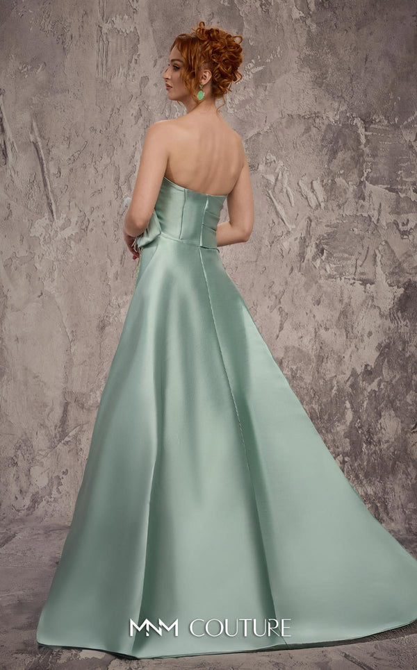 MNM Couture Style J03497 strapless column gown with a beaded skirt, satin train, and asymmetrical deep V-neck. \ Couture Shop LA