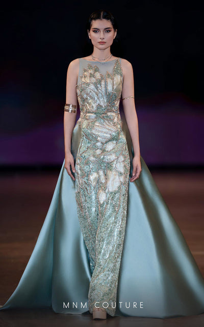 MNM Couture Style J03503 beaded column gown with a double skirt train and sheer neckline. \ Couture Shop LA