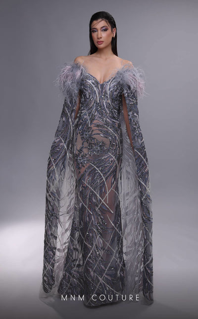 MNM Couture K4097 mermaid gown with sheer cape sleeves, feather details, and intricate beaded motifs. | Couture Shop LA