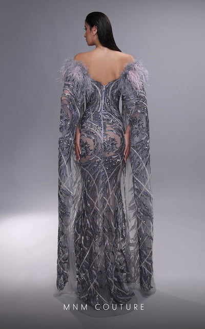 MNM Couture K4097 mermaid gown with sheer cape sleeves, feather details, and intricate beaded motifs. | Couture Shop LA