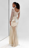 MNM Couture M1312 in gold Lycra satin, showcasing a mermaid silhouette with a beaded illusion bodice, long sheer sleeves, and a draped, gathered waist. | Couture Shop LA