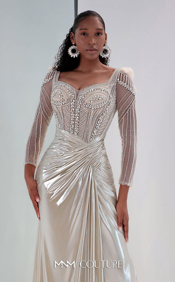 MNM Couture M1312 in gold Lycra satin, showcasing a mermaid silhouette with a beaded illusion bodice, long sheer sleeves, and a draped, gathered waist. | Couture Shop LA