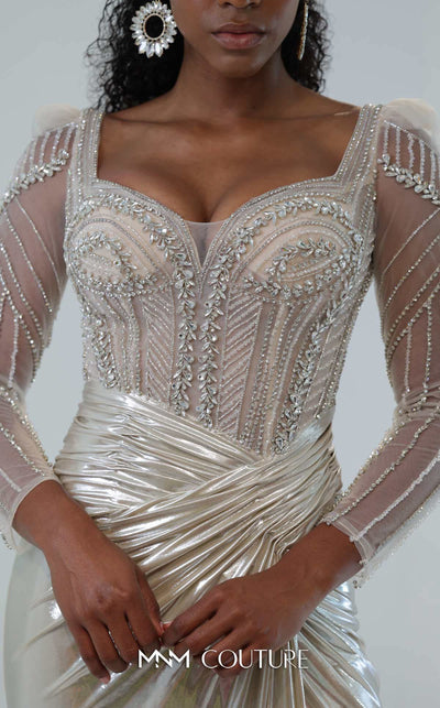 MNM Couture M1312 in gold Lycra satin, showcasing a mermaid silhouette with a beaded illusion bodice, long sheer sleeves, and a draped, gathered waist. | Couture Shop LA