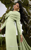 MNM Couture N0672 light green column gown with long-sleeve halter neck, pleated bust, and a single-sided long cape. | Couture Shop LA