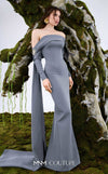 MNM Couture Style N0674 showcasing a brown fitted column gown with straight-across pleated neckline, long sleeves, asymmetrical design, flower brooch, and flowing train | Couture Shop LA