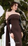 MNM Couture Style N0674 showcasing a brown fitted column gown with straight-across pleated neckline, long sleeves, asymmetrical design, flower brooch, and flowing train | Couture Shop LA