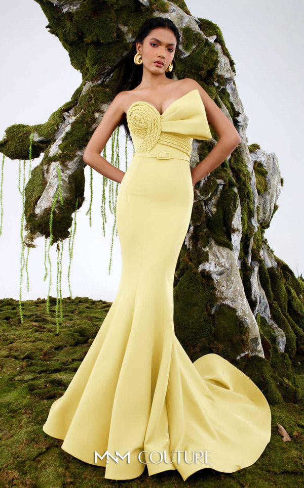 MNM Couture Style N0676 in mocha, showcasing a mermaid silhouette with an asymmetric sweetheart neckline, a half-bow detail on the bust, braided strap accents, and a long train. | Couture Shop LA