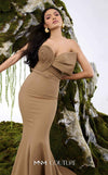 MNM Couture Style N0676 in mocha, showcasing a mermaid silhouette with an asymmetric sweetheart neckline, a half-bow detail on the bust, braided strap accents, and a long train. | Couture Shop LA