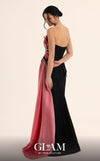 MNM Couture O07806 black crepe strapless column gown with oversized 3D fuchsia floral crystal starburst bodice, triangular peplum with inverted V open back, and sweeping fuchsia organza panel | Couture Shop LA