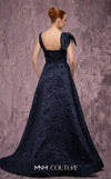 MNM Couture Style Q1150 navy blue brocade ballgown with deep V-neckline, mesh inset, bow detail, and gold and crystal floral embellishments at waist and shoulder. | Couture Shop LA