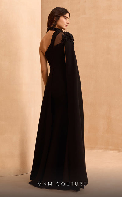 MNM Couture V02037A black rayon crepe dress with cape sleeve, asymmetric neckline, and rhinestones.| Couture Shop LA