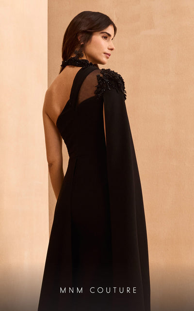 MNM Couture V02037A black rayon crepe dress with cape sleeve, asymmetric neckline, and rhinestones.| Couture Shop LA