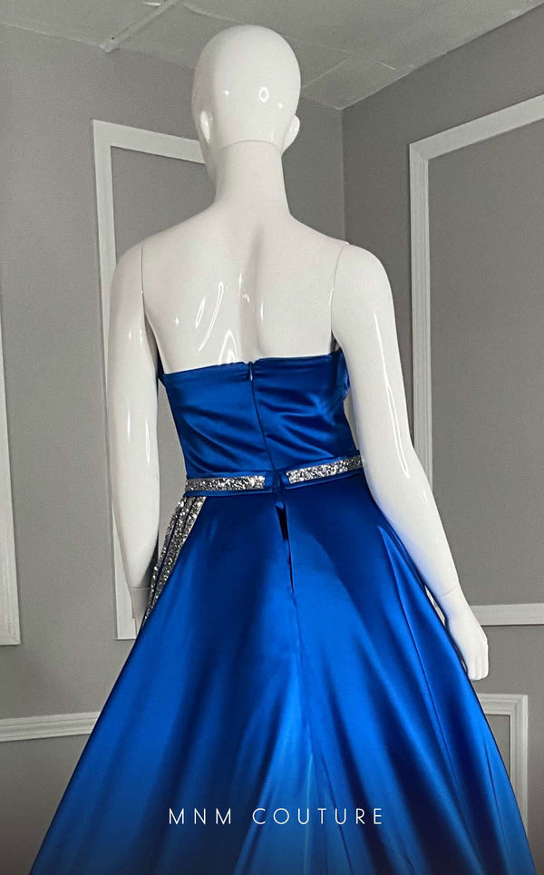 MNM Couture V07353 asymetric sleevless satin column gown with ruffles and beadwork. | Couture Shop LA