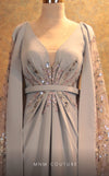 GLAM by MNM Couture V6463 grey gown with embroidered cape sleeves and pleated bodice | Couture Shop LA
