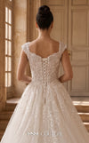 MNM Couture W2314 white off-shoulder ball gown wedding dress with structured flat shoulder drapes, pearl-beaded lace sweetheart bodice, 3D floral appliqués massed at the hem, corset lace-up back, and separate back overskirt with cathedral train | Couture Shop LA