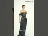 Robe fourreau MNM Couture O07832 en crêpe noir à épaules dénudées, ornée d'une cascade d'appliqués floraux et botaniques en 3D, d'une surjupe drapée asymétrique et d'une fente haute.